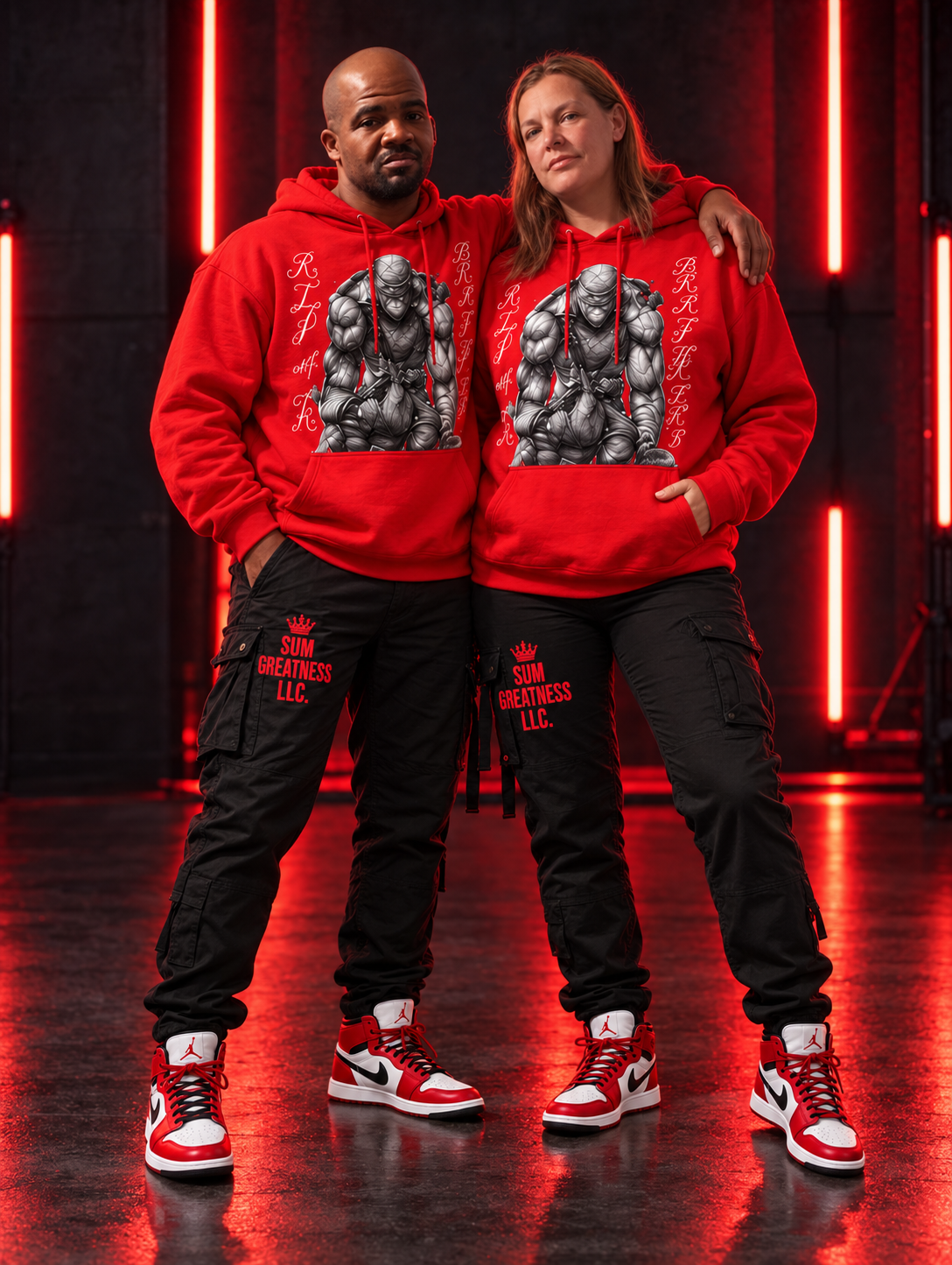 Kevin and his wife proudly wearing red SUM GREATNESS artwork hoodies